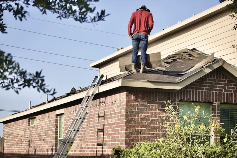 Professional roofer working on a residential roof in Atlantic Shores
